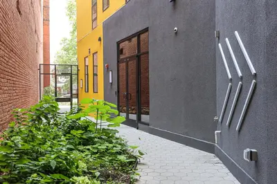 an alley with doors and plants next to a building at Studio Apartment in the Heart of Philadelphia in Philadelphia