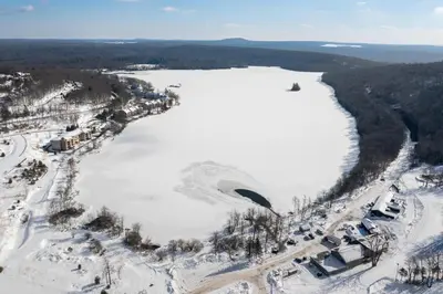 an aerial view of a lake in the snow at Iron Hill in Lake Harmony