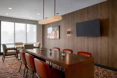 a conference room with a table and chairs and a tv at Fairfield by Marriott Inn & Suites Lancaster in Lancaster
