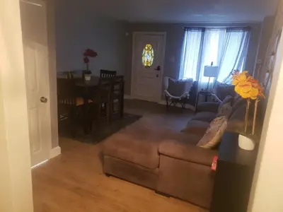 a living room with a couch and a table at Orchard Room by the Airport - Shared Space in Darby
