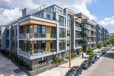 an apartment building on a street with parked cars at Designer Studio Loft - Balcony Pool Gym in Philadelphia
