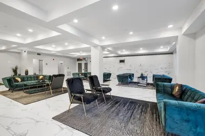 a lobby with couches and chairs in a room at Cozy Luxe Studio - Workstation WasherDryer in Philadelphia