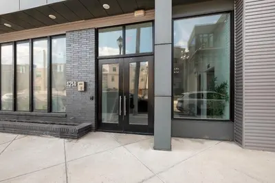 an entrance to a building with glass doors at Urban Retreat Studio - Balcony Smart Design in Philadelphia