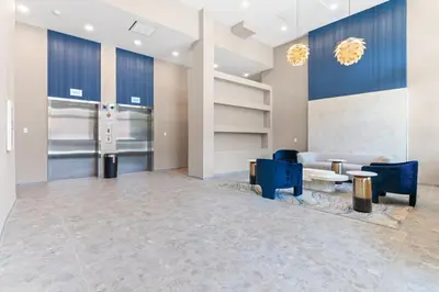 a lobby with blue chairs and a couch at 5 mins to FishTown plus Old Town King Bed, Sleeps 4! in Philadelphia