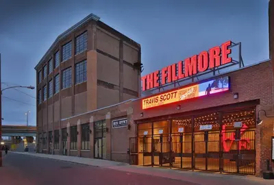 a large brick building with a sign that reads the audience at 5 mins to Convention Center! Sleeps 4! With Rooftop! in Philadelphia