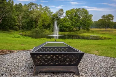 a statue in front of a fountain in a park at 2BR Premium Duplex Close to Ski Slopes in Pleasant Mount