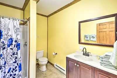 a bathroom with a sink and a toilet and a mirror at 2BR Premium Duplex Close to Ski Slopes in Pleasant Mount