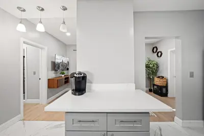 a kitchen with a white counter top in a room at Spacious Stay Near EWR And NYC Mins to Train in Bayonne