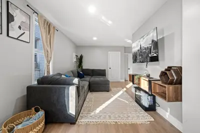a living room with a couch and a tv at The City Spacious Stay Near EWR And NYC Mins to Train in Bayonne