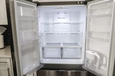 an empty refrigerator with its door open in a kitchen at 8BR 4BA Home Near NYC -Sleeps 16 in Irvington