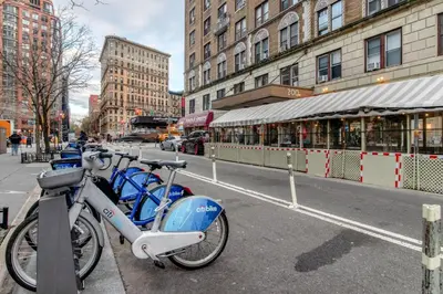 a group of bikes parked on a city street at UWS 2br w wd doorman gym nr Central Park NYC-1082 in New York
