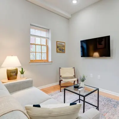 a living room with a couch and a table at Cozy 1BD With Balcony in Philadelphia