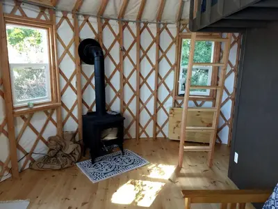 a room with a wood stove in a yurt at Beautiful Yurt with Breathtaking Views in Livingston Manor, New York in Livingston Manor