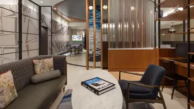a living room with a couch and a table and chairs at The Vibe on 5th Vibe 8750 in New York