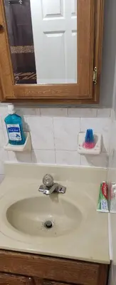 a bathroom counter with a sink and a mirror at Honey queen room 5 in Newark