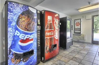 a room with two vending machines with soda cans at Cumberland Inn By OYO New Cumberland-Hershey South in New Cumberland