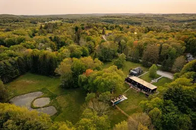 an aerial view of a house in the middle of a forest at The Rest Suite 5 in Kenoza Lake
