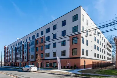 a building with a car parked in front of it at Opulence in Olive 4 bedrooms, 4 baths with 10 beds, Park 2 cars FREE in Orange