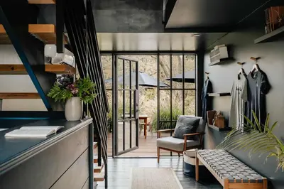 a living room with a couch and a chair at Coop 003 in Kenoza Lake