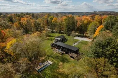 an aerial view of a house in the middle of a forest at Coop 004 in Kenoza Lake