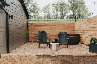two chairs and a table in a backyard at Luxury Cabin getaway with hot tub and stunning views in Strasburg