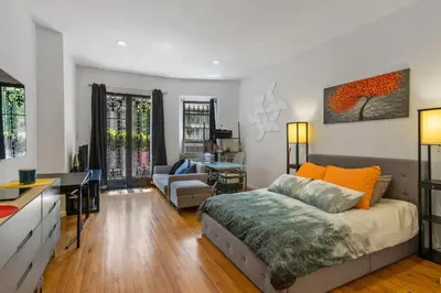 a bedroom with a bed and a living room at Stylish Studio in Central Park Best Location Ever in New York