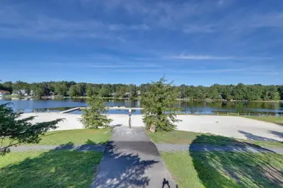 an empty park with a lake in the background at Poconos Family Home with Lake Access and Game Room in Tobyhanna