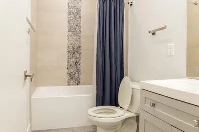 a bathroom with a toilet and a tub and a sink at 2BR2BA ApartmentWDWiFi Near Temple in Philadelphia