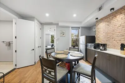 a kitchen and dining room with a table and chairs at Luxury and Chic 2BR 2BA Apt Mins to NYC and Hoboken in Jersey City