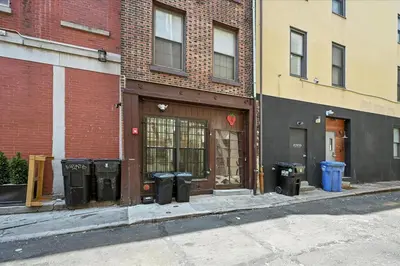 a building with trash cans on the side of a street at Charming Philly Stay Walk to Liberty Bell & More in Philadelphia