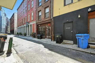 an empty city street with trash cans and buildings at Charming Philly Stay Walk to Liberty Bell & More in Philadelphia