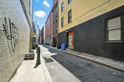 an empty street in a city with buildings at Cozy Modern Studio Perfect for Short or Long Stays in Philadelphia