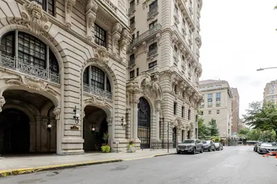 a large building with cars parked on a city street at Blueground Upper West Side wd nr Central Park NYC-1860 in New York
