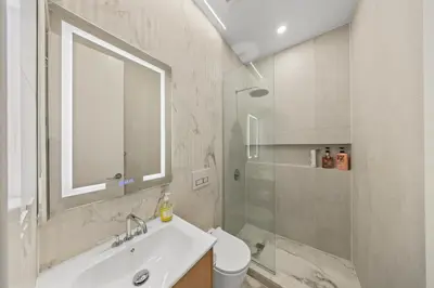 a white bathroom with a sink and a shower at Private room by Times Square Manhattan in New York