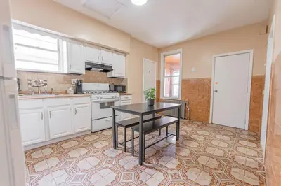a kitchen with a table in the middle of it at NYC Train EWR Liberty Park 1 in Bayonne