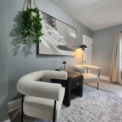 a living room with two chairs and a table at Private Bedroom In Shared Apt C in South Hackensack