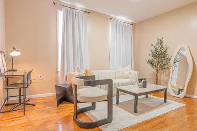 a living room with a couch and a table at Roomy 4br Walk to Transit connect to NYC in Bayonne