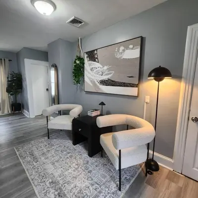 a living room with two chairs and a table at Private Bedroom In Shared Apt B in South Hackensack