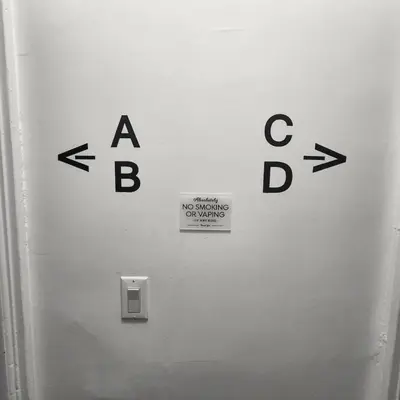 a sign on a wall with arrows on it at Private Bedroom In Shared Apt B in South Hackensack