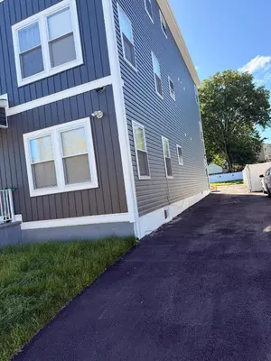 a house with a driveway next to a building at The great homes in East Orange