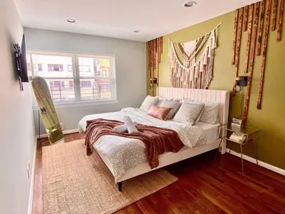 a bedroom with a bed and a window at Easy PATH&Bus access- NYC designer home & Terrace in Jersey City