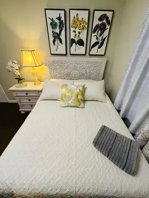 a bedroom with a large white bed with two pillows at The Peaceful Perch Retreat Near NYC Elle's Home in Trenton