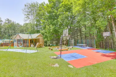 a playground with a basketball hoop in a yard at Community Perks Mongaup Valley Cabin with Grill! in Mongaup Valley