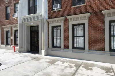 a large brick building with black doors and windows at Blueground Bloomingdale fitness center nr Central Park NYC-1869 in New York