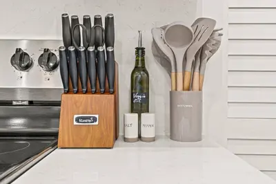 a knife block with a bottle of wine and utensils at New townhouse SLEEP 4 Best Spot-Old City Philly in Philadelphia