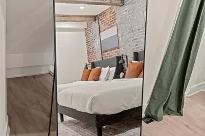a bedroom with a bed and a brick wall at New Townhouse Sleep 4 Old City Walk to Everything! in Philadelphia