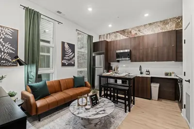 a living room with a couch and a kitchen at In The Center of Old City Philly- Walker Paradise! in Philadelphia
