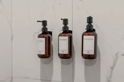 three bottles of soap sitting on a shelf at Sleep 3- Beautiful Unit- Walk Around in Old City in Philadelphia