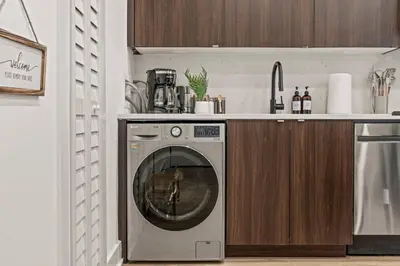 a washing machine in a kitchen with a counter at Sleep 3- Beautiful Unit- Walk Around in Old City in Philadelphia