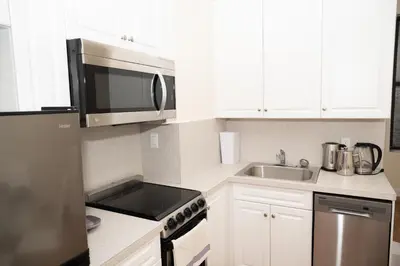 a kitchen with a microwave and a sink at East Village Center Apartment7 w Full Amenities Great New York Location in New York